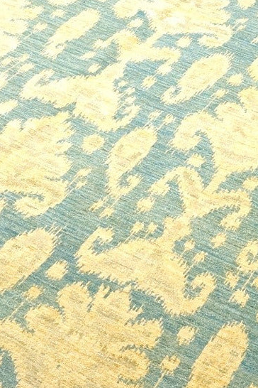 Yellow and blue patterned rug on a white background